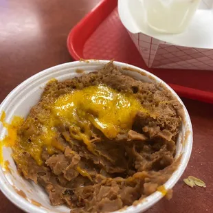 a bowl of taco with cheese on top