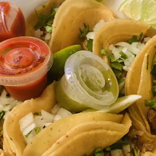 a plate of tacos and salsa