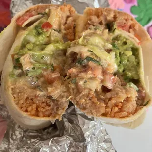 The chicken stuffed burrito filled with beans, Spanish rice, guacamole, cheese, and other sauces !