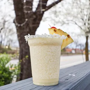 a drink with a pineapple garnish