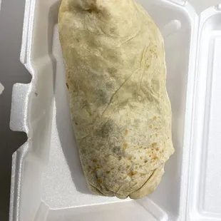 a burrito in a styrofoam container