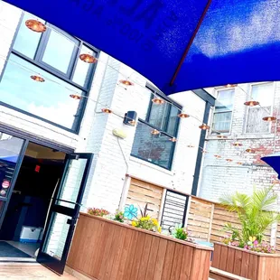 a blue umbrella outside of a restaurant