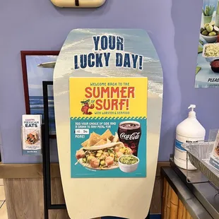 a surfboard with a sign that says your lucky day