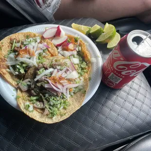 a plate of food and a can of coke