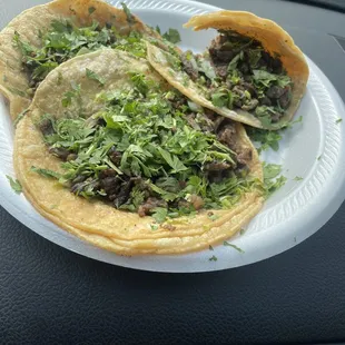 two tacos on a paper plate