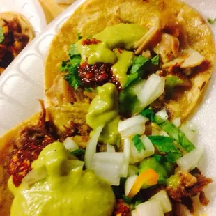 two tacos on a paper plate