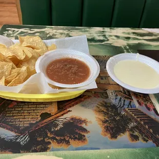 a plate of chips and a bowl of salsa