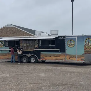 people standing in front of a food truck
