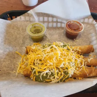 3 taquitos. Guacamole &amp; cheese with a Verde &amp; hot salsa on the side.