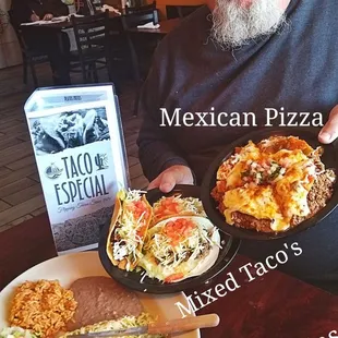 a man holding two plates of food