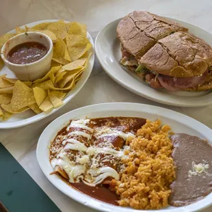 Torta, chips, salsa,  and enchiladas