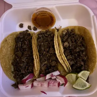 3 Tacos of steak on double corn tortilla.