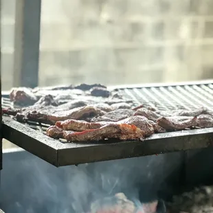 meat being cooked on a grill