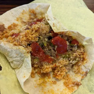 A regular burrito opened so I could add picante sauce. Very good. Filling. Would get this again.