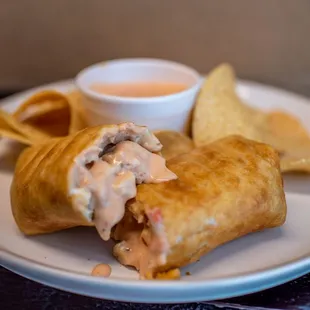 a plate of food with chips and dip