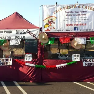 a taco stand in a parking lot