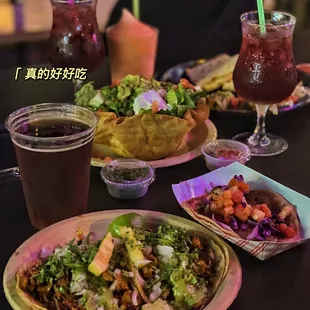 a plate of tacos and a drink