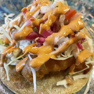 a taco with sauce and toppings