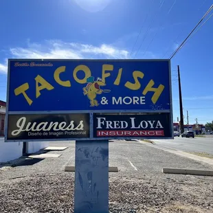 a taco fish and more sign