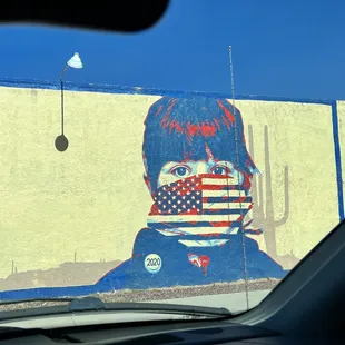 a man with a flag painted on a wall