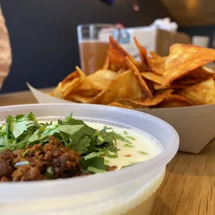 Chips and queso. Pro tip: ask for less seasoning on the chips!