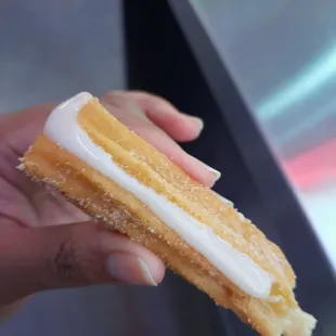 a hand holding a pastry