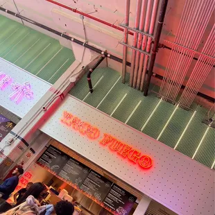 a neon sign above a restaurant