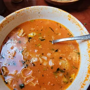 a bowl of soup and a plate of tortillas