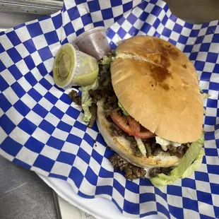 a hamburger with lettuce and tomato