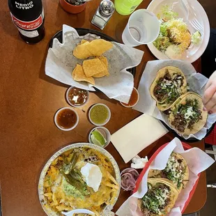 Asada Tacos, Carnitas Tacos, Chicken Crunchy Taco, Al Pastor Fries.