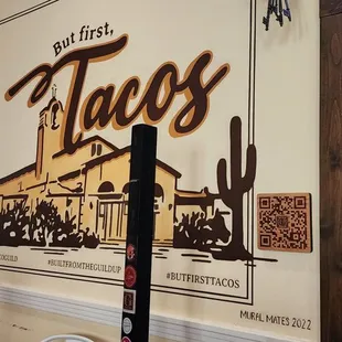 a taco bar with a sign on the wall