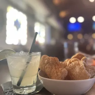 a bowl of doughnuts and a glass of lemonade