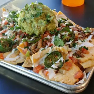 a tray of nachos with guacamole