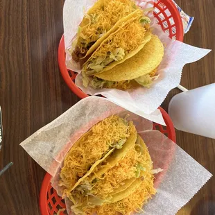 three tacoss in baskets on a table