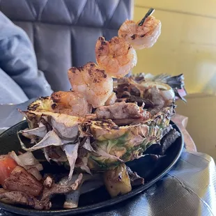 a grilled pineapple with shrimp