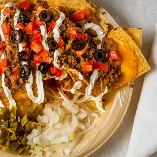 a plate of nachos with toppings