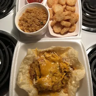 Chicken rice bowl, potato things, Spanish rice, and side of salsa.