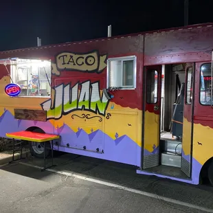 a colorful food truck parked in a parking lot