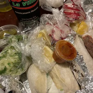 a variety of food wrapped in foil