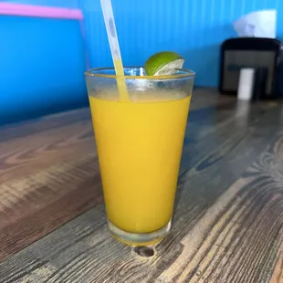 a glass of orange juice on a table