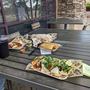 Tacos, tamales, street corn, and drink.