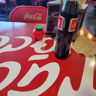 a bottle of coca cola on a table