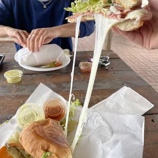 a person eating a large sandwich