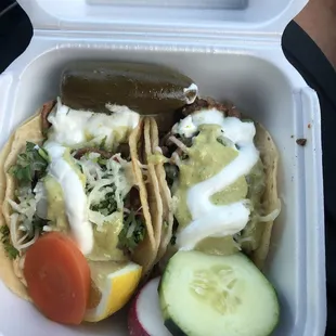 Asada tacos with sour cream and cheese