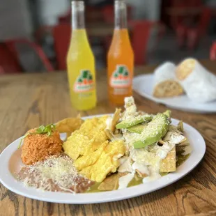 a plate of food and a bottle of orange juice