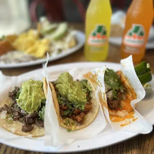 a plate of tacos with guacamole