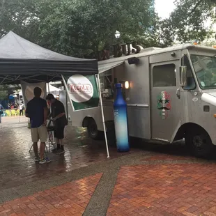 people standing under a tent