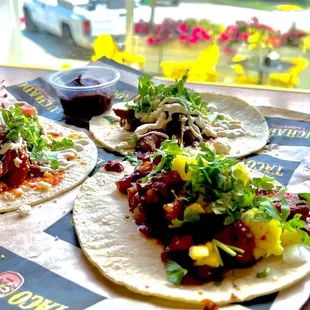 three tacos on a table