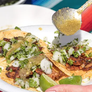 Thinly sliced Al pastor on handmade tortillas