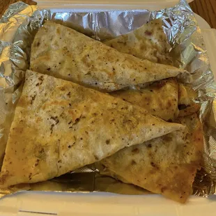 three quesadillas in a container